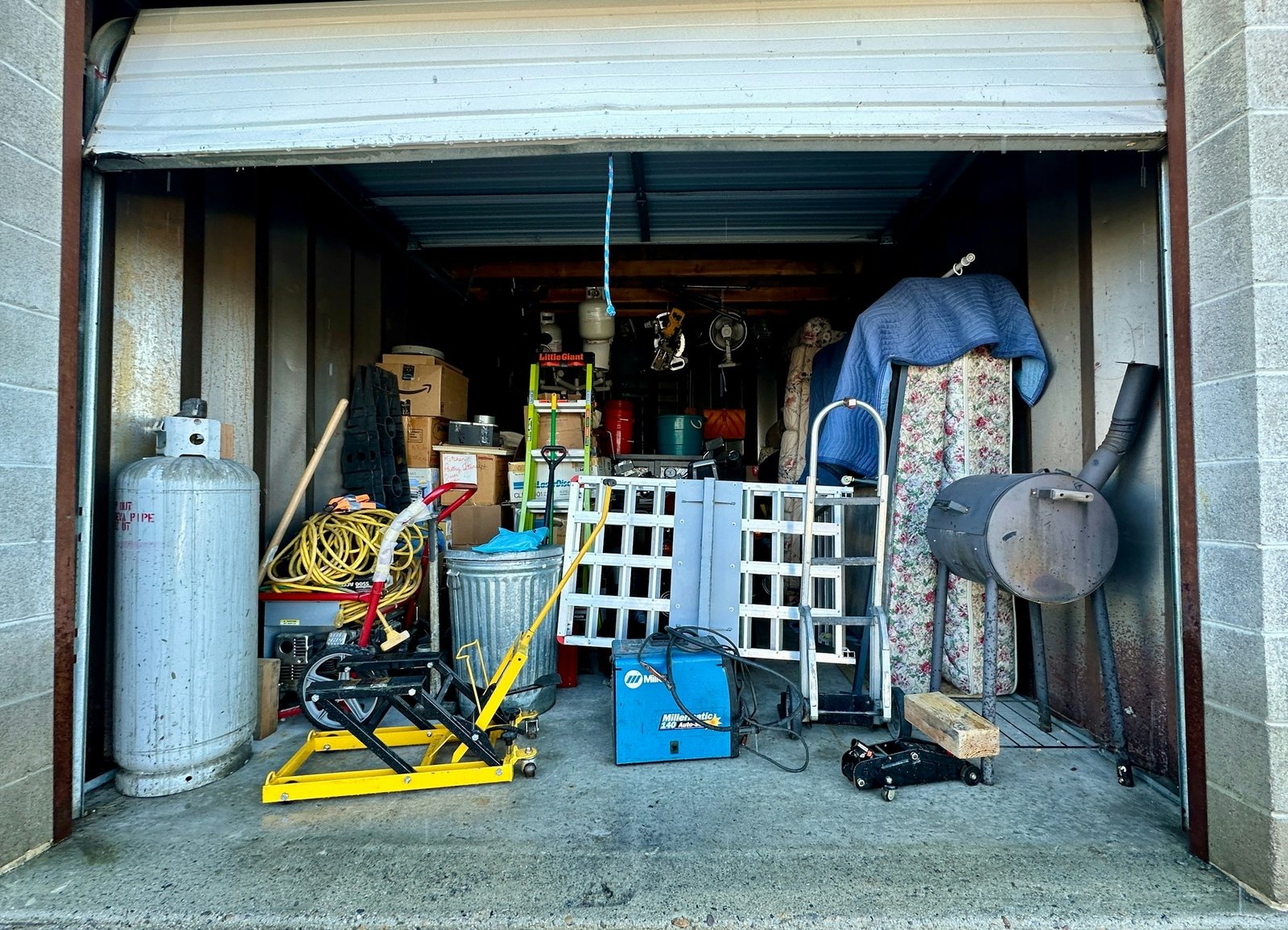 Garage shelves packed with stored household goods awaiting a cleanout