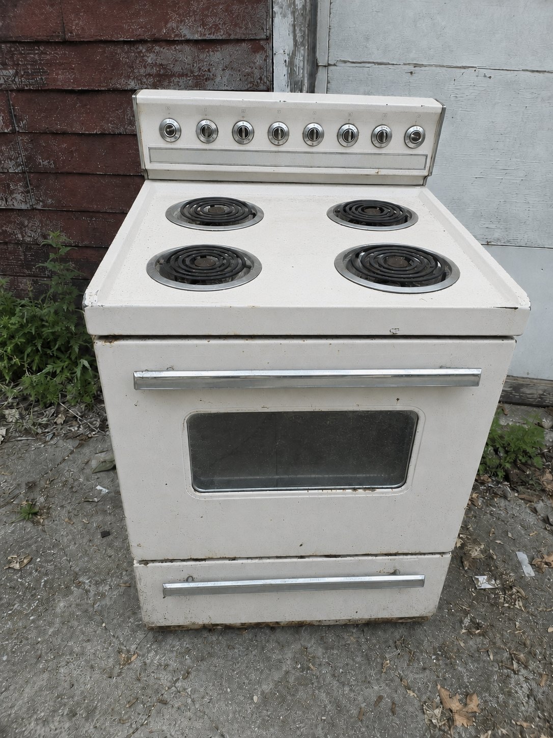 Old white kitchen range set out for pickup